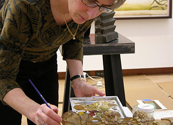 Sue Jackson Inpainting areas of gilding loss on a gilded frame, New Britain Museum of American Art