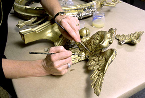 Repairing carved and molded detail of eagle gilt framed mirror